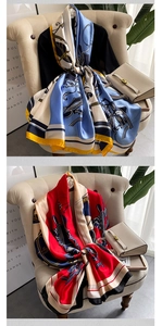 Detailed view of large silky geometric print scarves in blue, yellow, and red colorways