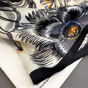 Silk square scarf featuring black and white floral print with premium satin finish