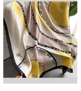 Detail of elegant satin scarf draped on a chair showing smooth texture and floral pattern