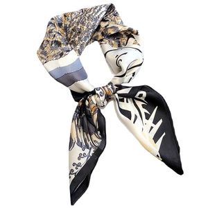 Elegant silk scarf with leopard black jungle floral print tied in a stylish bow knot