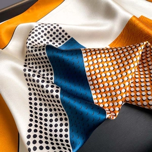 Silk satin square scarf with geometric print and polka dots shown in detailed folds