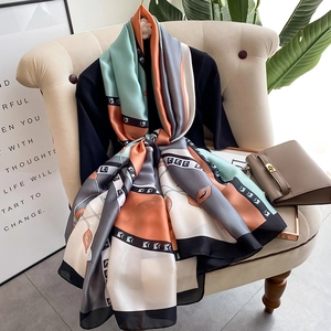Elegant geometric silk-satin scarf with orange and mint color block patterns