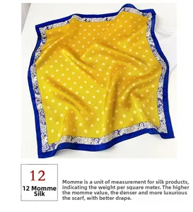 Detail of 12 momme mulberry silk square scarf with blue paisley pattern on yellow silk
