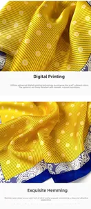 Detail of digital printed silk scarf featuring yellow daisies and paisley border craftsmanship