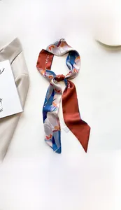 Close-up of 7x130cm printed silk scarf with floral patterns on a blazer