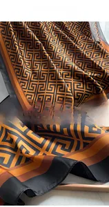 Close-up of Greek key pattern silk shawl showing detailed edge stitching and smooth texture