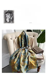 Detail of elegant navy silk scarf with golden feather prints draped on a chair