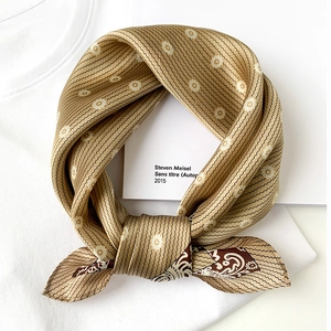 Khaki silk square scarf with daisy patterns and paisley border on a white T-shirt