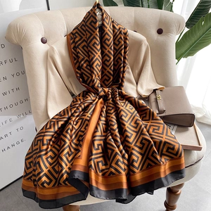 Elegant silk-feel beach shawl with orange and brown geometric maze patterns