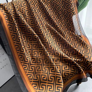 Elegant silk shawl with orange and black Greek key geometric pattern for beach sun protection