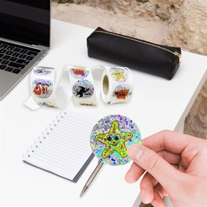 Detailed holographic marine life stickers with glitter finish on a laptop and notebook