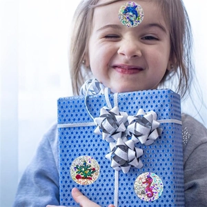 Holographic sea life stickers with dolphins and seahorses shown on gift boxes and skin