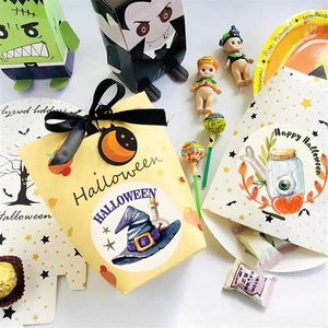 Close-up of Halloween gift boxes featuring cartoon monsters and matching ribbon closures