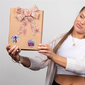 Close-up of glitter ocean stickers with seahorse and octopus on a kraft paper gift box