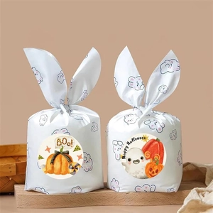 Detail of Halloween ghost and pumpkin stickers on purple bunny ear gift packaging bags