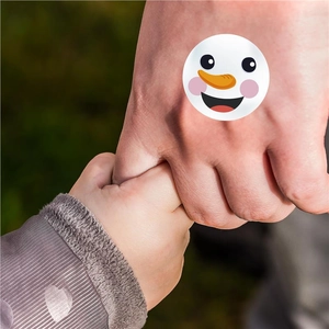 Cute snowman face stickers on hand, perfect festive Christmas decoration for kids