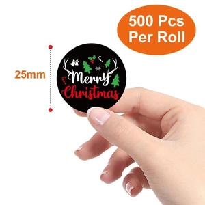 Detail of 25mm Merry Christmas stickers roll with reindeer and tree motifs on black base