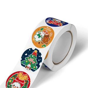 Roll of round Christmas stickers with gingerbread man and puppy for holiday gift packaging