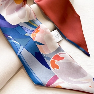Detailed view of floral printed silk scarf with vibrant colors and fine stitching