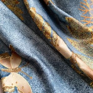 Detailed macro view of the soft faux silk fabric texture with elegant butterfly prints