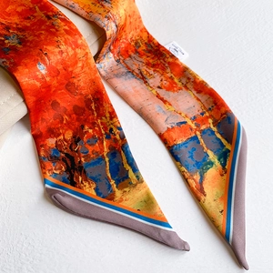 Close-up of impressionist oil painting print silk twilly scarf tied on a leather bag
