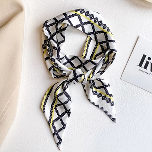 Elegant long silk scarf with yellow and black geometric patterns on a white background