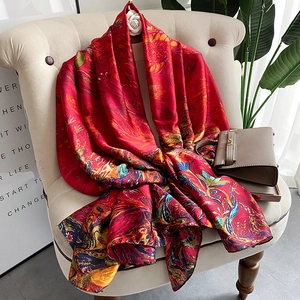 Elegant red artistic oil painting floral silk shawl draped on a modern sofa