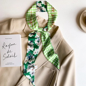 Double-sided floral and checkerboard silk twilly scarf styled on a beige blazer