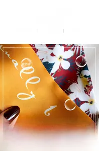 Macro shot of silk neckerchief showing delicate inner stitching and vibrant floral patterns