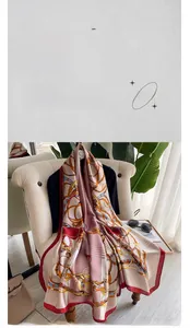 Detail of silk scarf with equestrian chain print draped on a chair in a lifestyle setting