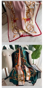 Detail of vintage equestrian silk scarf with horse and stirrup pattern on a chair