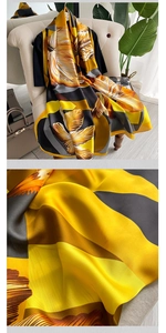 Detail of elegant oversized silk scarf with vintage orange floral pattern and satin finish