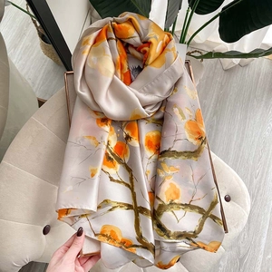 Elegant long silk shawl with persimmon floral patterns for sun protection and travel