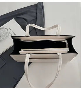 Detailed interior of minimalist tote bag showing practical zip compartment and lining