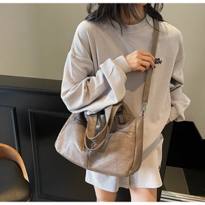 Détail d'un grand sac cabas marron foncé avec texture plissée rétro et bandoulière réglable