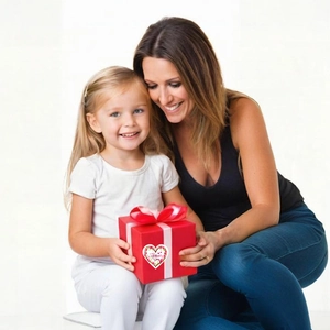 Close-up of heart floral sticker saying Happy Mother's Day on a red gift box