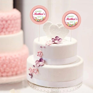 Detail of pink floral Happy Mother's Day cake topper decoration on white cream cake