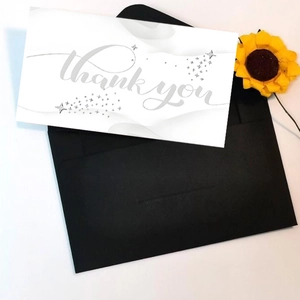 White Thank You card with grey script and black envelope with sunflower accent