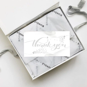 Minimalist white gift box with custom thank you card and printed tissue paper wrapping