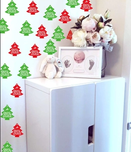 Detail of red and green Merry Christmas tree stickers applied on a home nursery wall