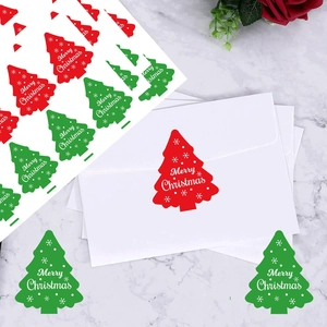 Christmas tree shaped stickers with Merry Christmas text on white envelopes