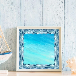 Artistic bulletin board border with blue and white ocean wave patterns on light wood desk