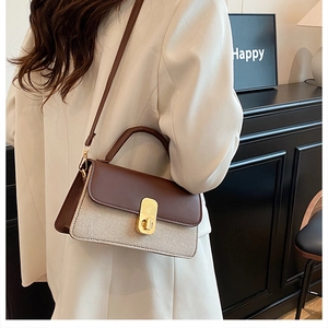 Detail of contrast color crossbody bag with leather flap and golden rotary lock buckle
