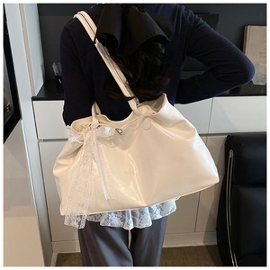 Detail of white glossy oil wax leather tote bag with lace pearl bow decoration
