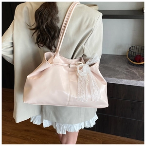 Pink oversized tote bag featuring delicate white lace bow and pearl details on side