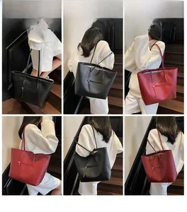 Detailed views of women large tote bag in black and red showing front zip and shoulder strap