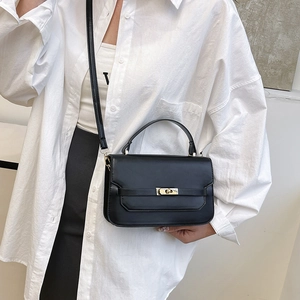 Classic black rectangular handbag with gold metal lock and adjustable shoulder strap
