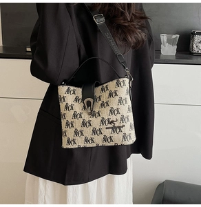 Detailed view of canvas bucket bag with ARCK logo print and adjustable strap