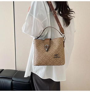 Detail of vintage printed bucket bag with golden kangaroo logo and jacquard strap