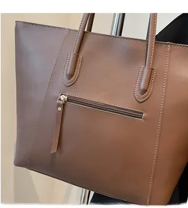 Detailed close-up of dark brown tote bag with high-quality PU leather and reinforced stitching